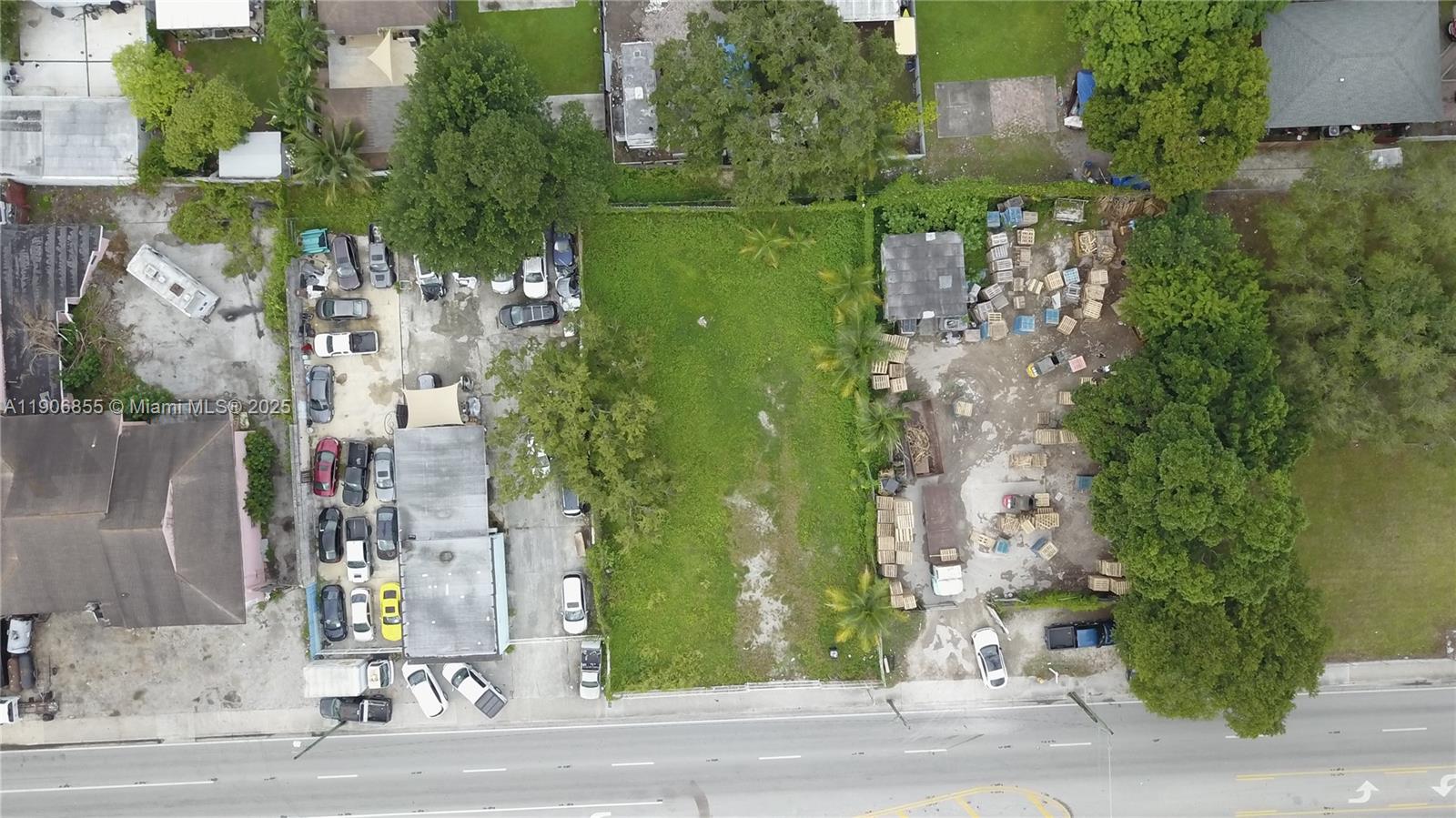 An aerial view shows two adjacent lots with a building, parked vehicles, and outdoor storage — 3039 NW 54th St, Miami FL 33142, MIAMI, FL