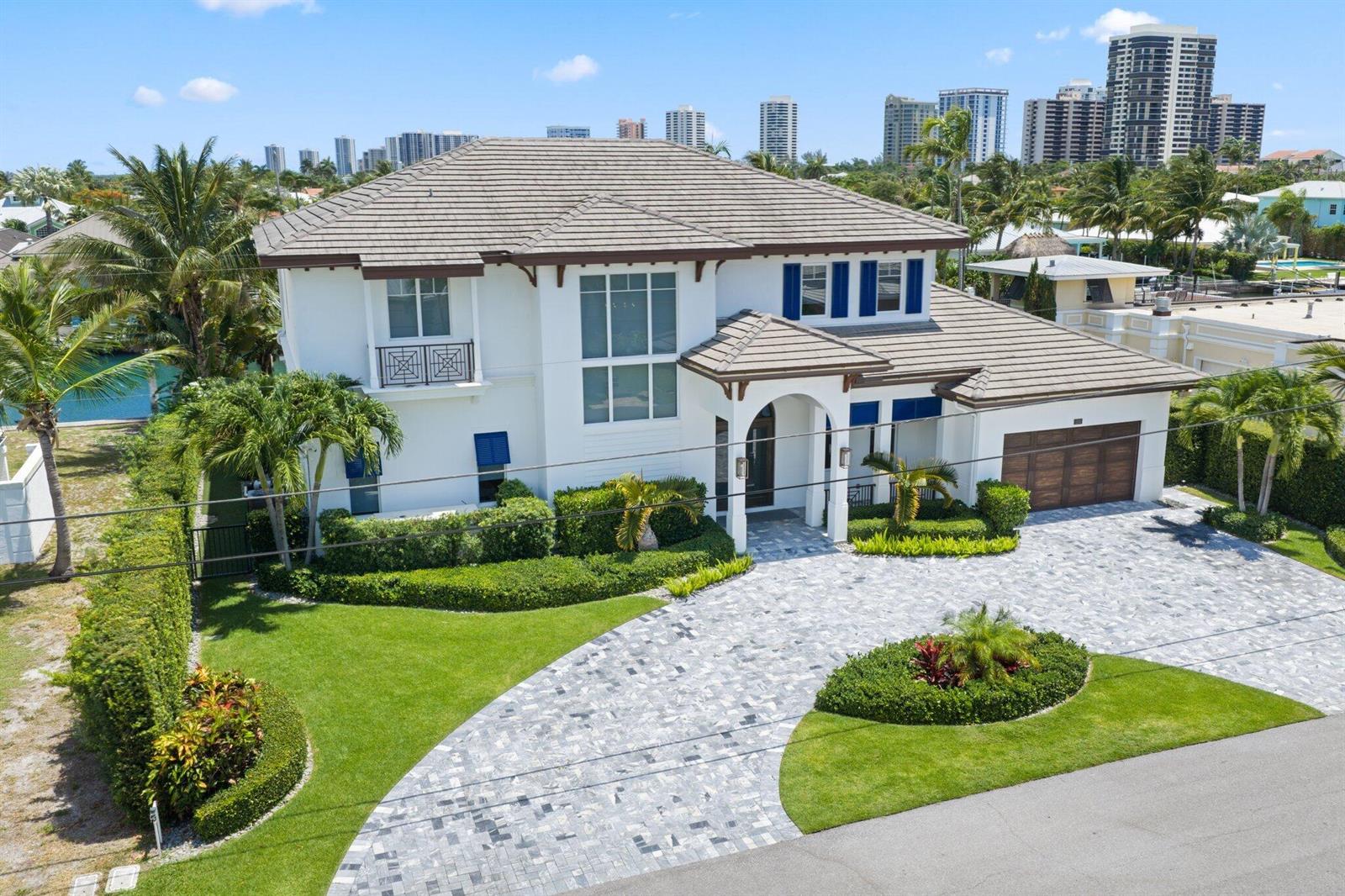 An aerial view of a two-story white house with a tiled roof and paved driveway — 1200 Bimini Lane, Singer Island FL 33404, SINGER ISLAND, FL