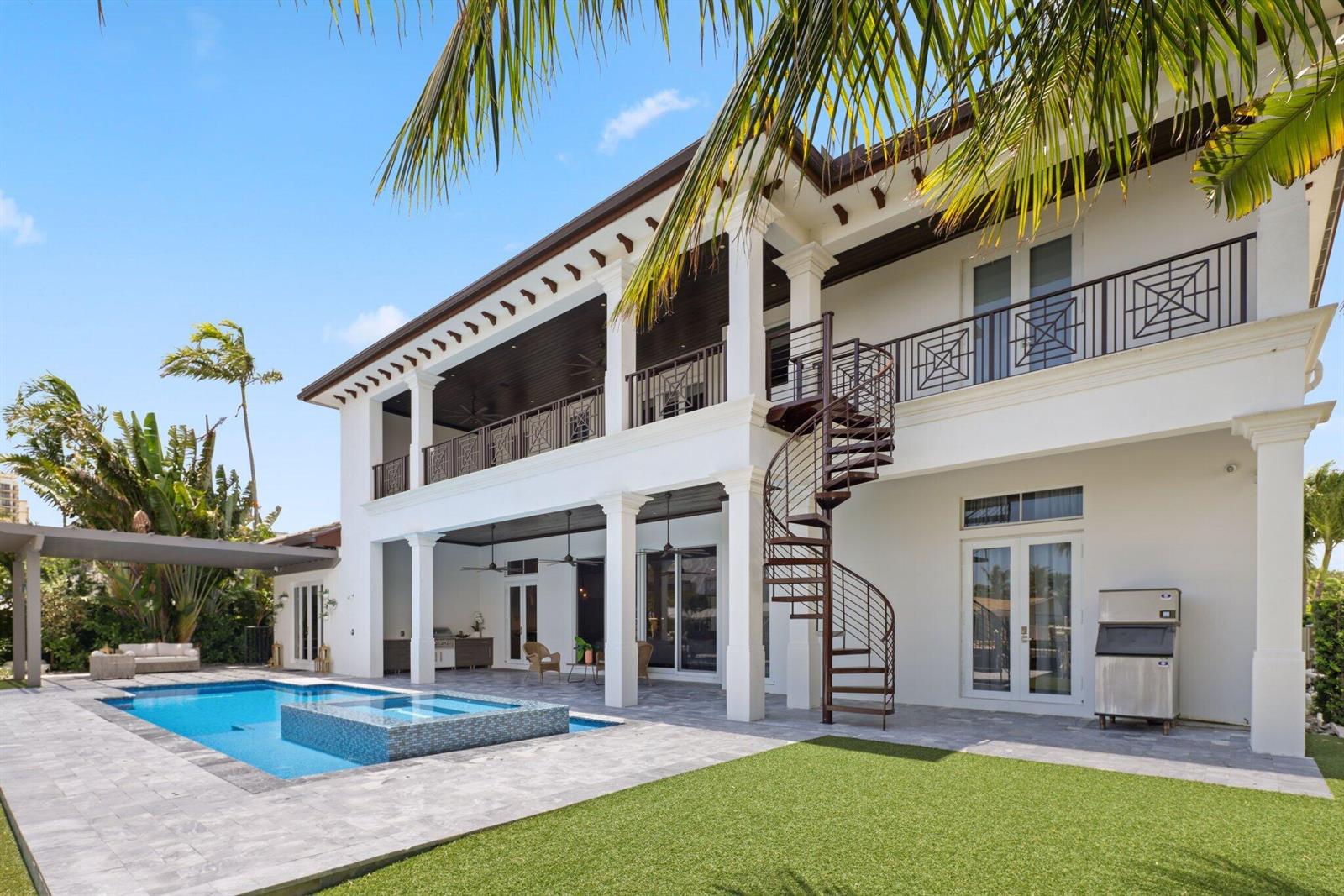 A two-story white house with a spiral staircase, balcony, and swimming pool in the backyard — 1200 Bimini Lane, Singer Island FL 33404, SINGER ISLAND, FL