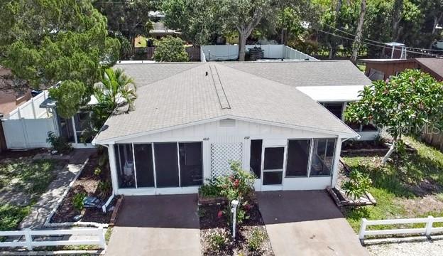 An aerial view shows a single-story duplex with two screened-in porches and a shingled roof — 4805 21ST STREET W, BRADENTON, FL