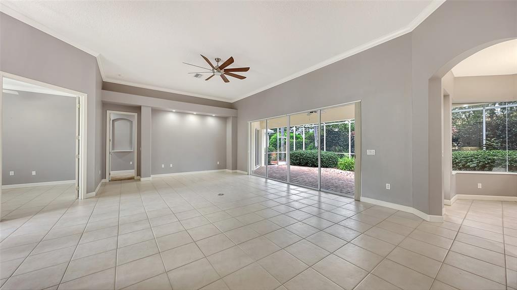 A spacious foyer with light tile flooring, gray walls, and double glass entry doors — 6209 CYPRESS BEND COURT, BRADENTON, FL