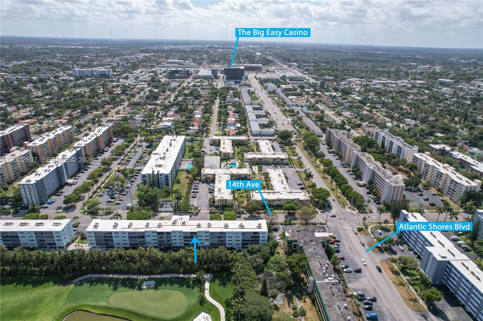 An aerial view shows a residential neighborhood with apartment buildings, a golf course, and nearby roads — 700 NE 14th Ave # 407, Hallandale Beach FL 33009, HALLANDALE BEACH, FL