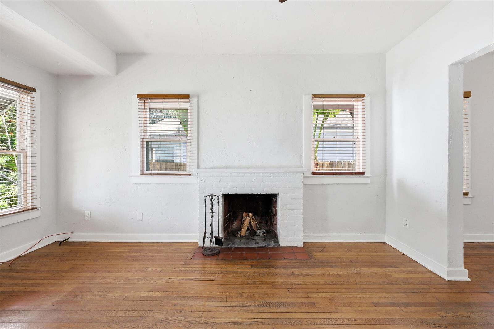 A living room features white walls, hardwood floors, and a central white brick fireplace — 918 N K Street, FL 33460, FL
