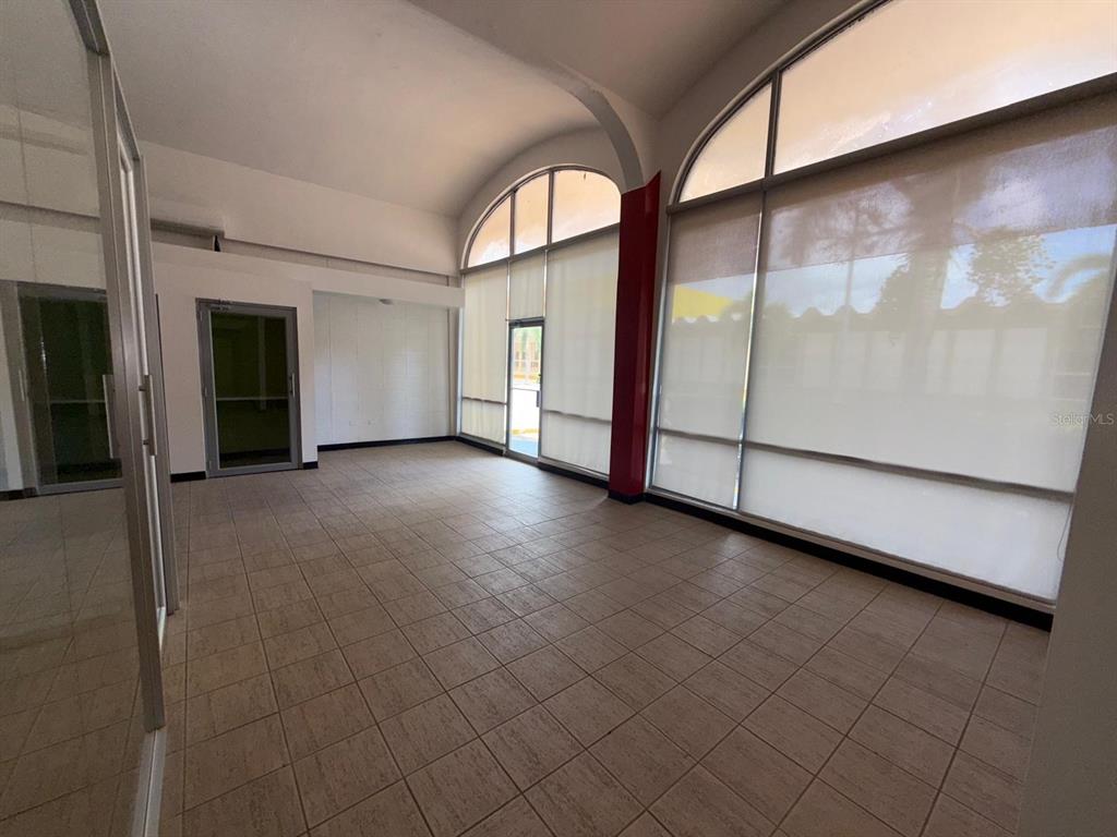 An empty room with tiled floors, arched windows, and white walls — 2822 AVE LAS AMÉRICAS, PONCE, PR