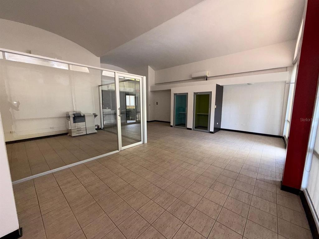 An office space with tiled floors, a glass-enclosed room, and two small private booths — 2822 AVE LAS AMÉRICAS, PONCE, PR