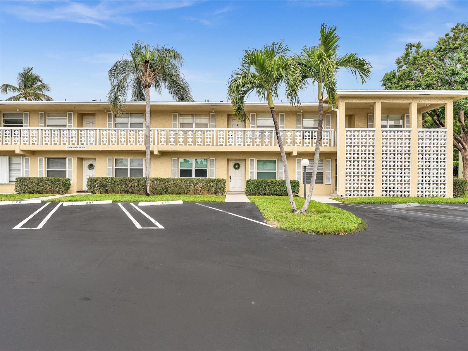 A two-story apartment building with a parking lot and palm trees in front — 1151 Calamondin Terrace, Delray Beach FL 33445, DELRAY BEACH, FL