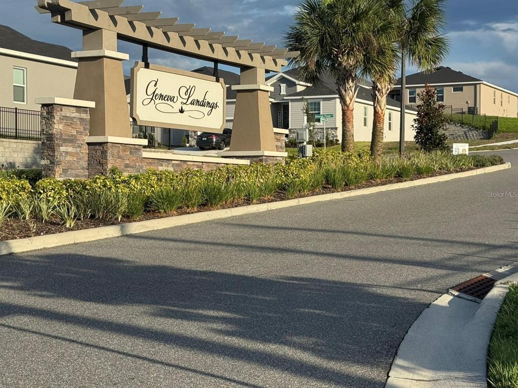 A stone and stucco monument sign marks the entrance to the Geneva Landings residential community — 1391 MOUNTAIN FLOWER LANE, DAVENPORT, FL