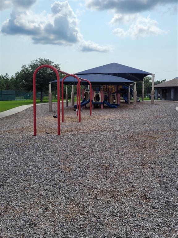 A playground features a swing set and a covered play structure on a wood-mulched surface — Lot 14 SW VIOLA COURT, DUNNELLON, FL