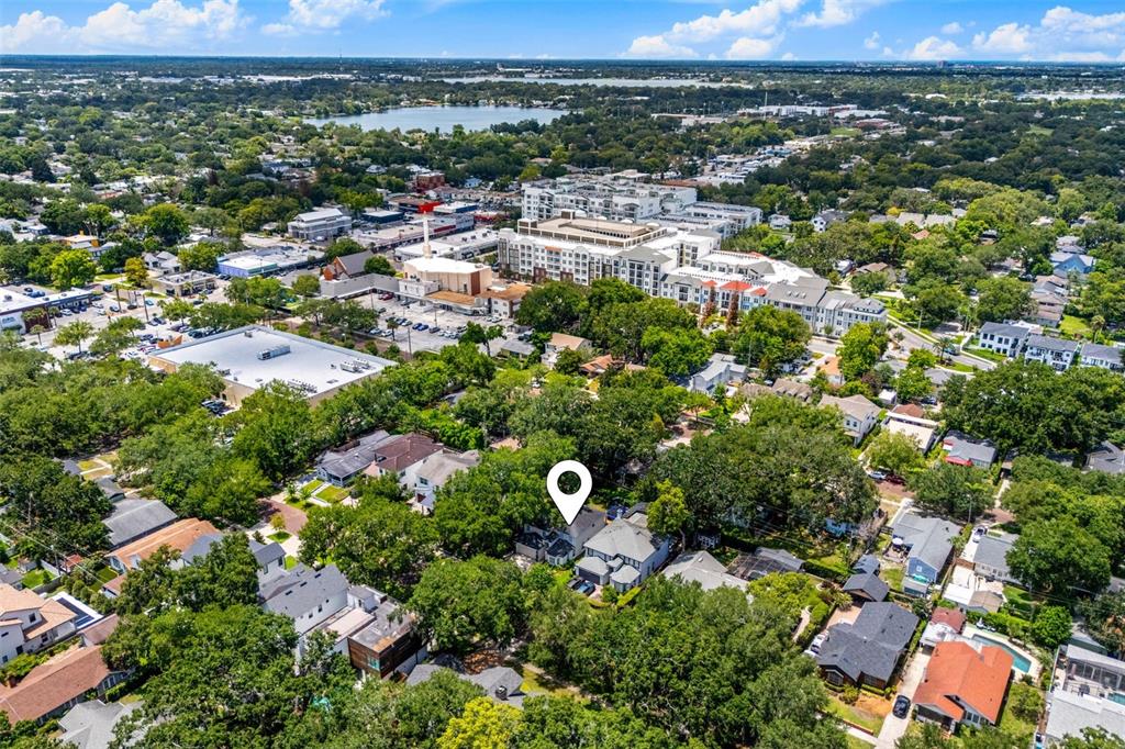 An aerial view shows a residential neighborhood with a marked house surrounded by trees — 533 W YALE STREET, ORLANDO, FL