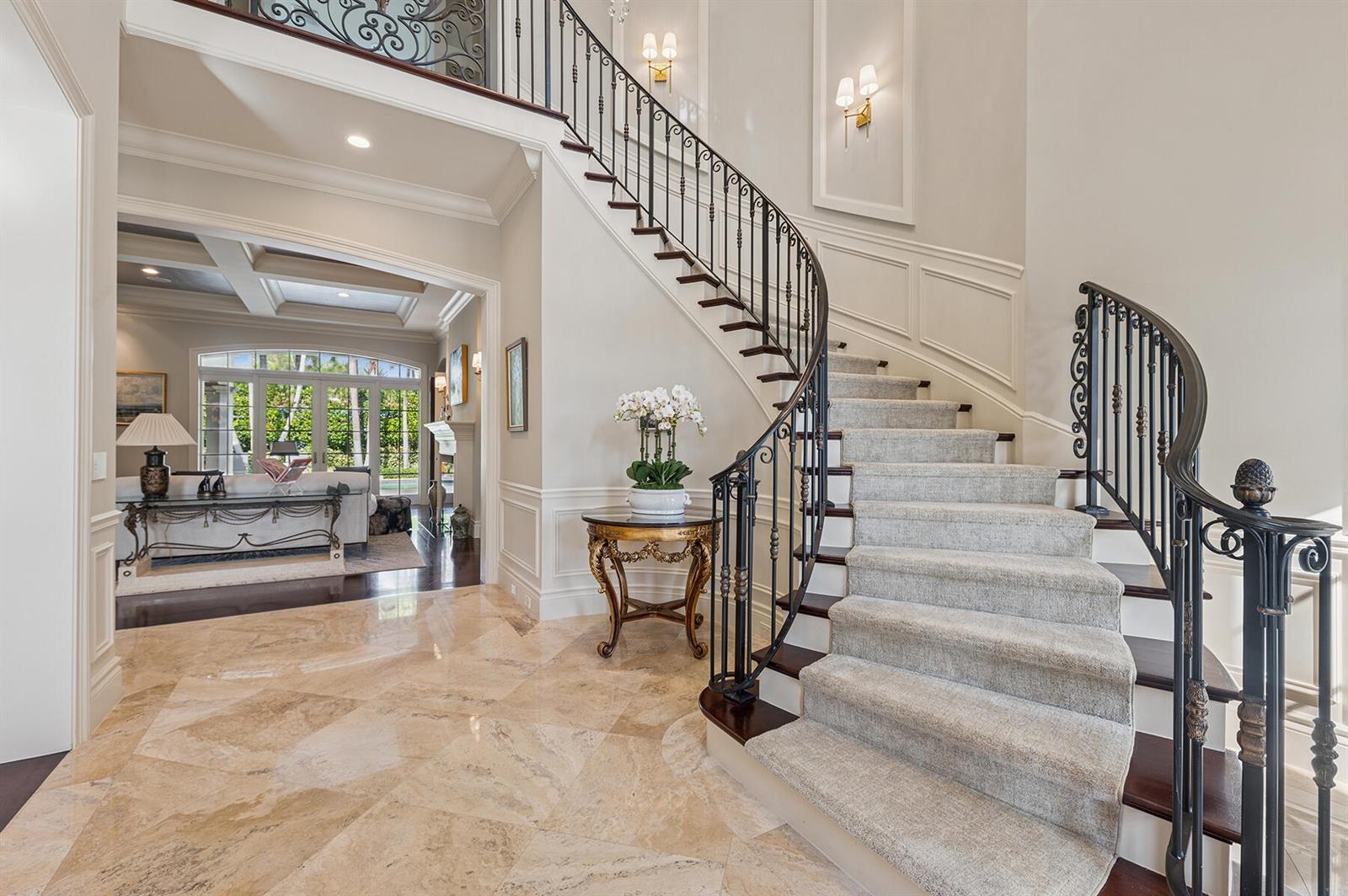 A grand foyer features a curved staircase with carpeted steps and a marble tile floor — 293 Sabal Palm Terrace, Boca Raton FL 33432, BOCA RATON, FL