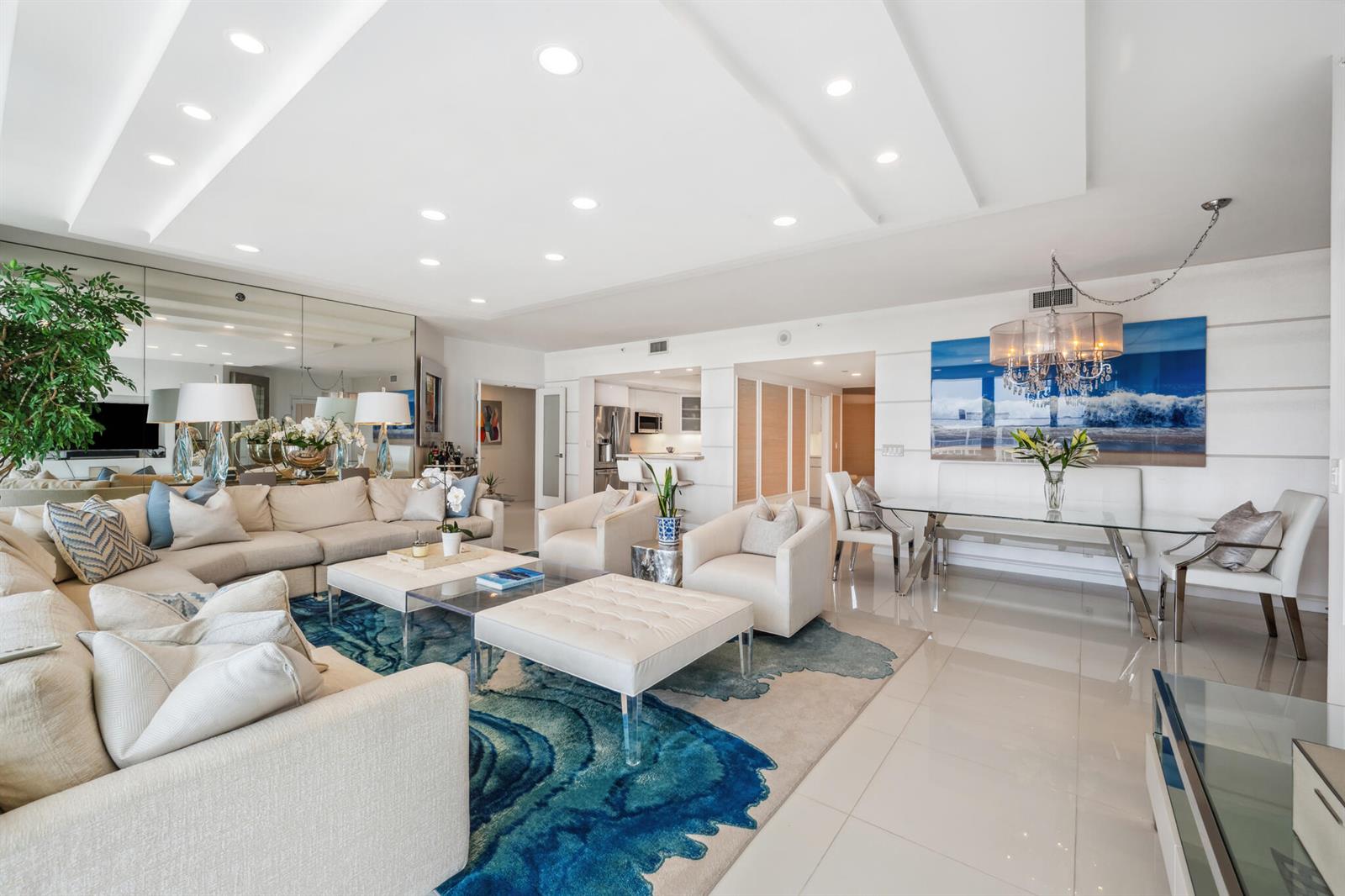 A bright, open-concept living and dining area features white tile floors and a blue rug — 2100 S Ocean Boulevard # 607n, Palm Beach FL 33480, PALM BEACH, FL