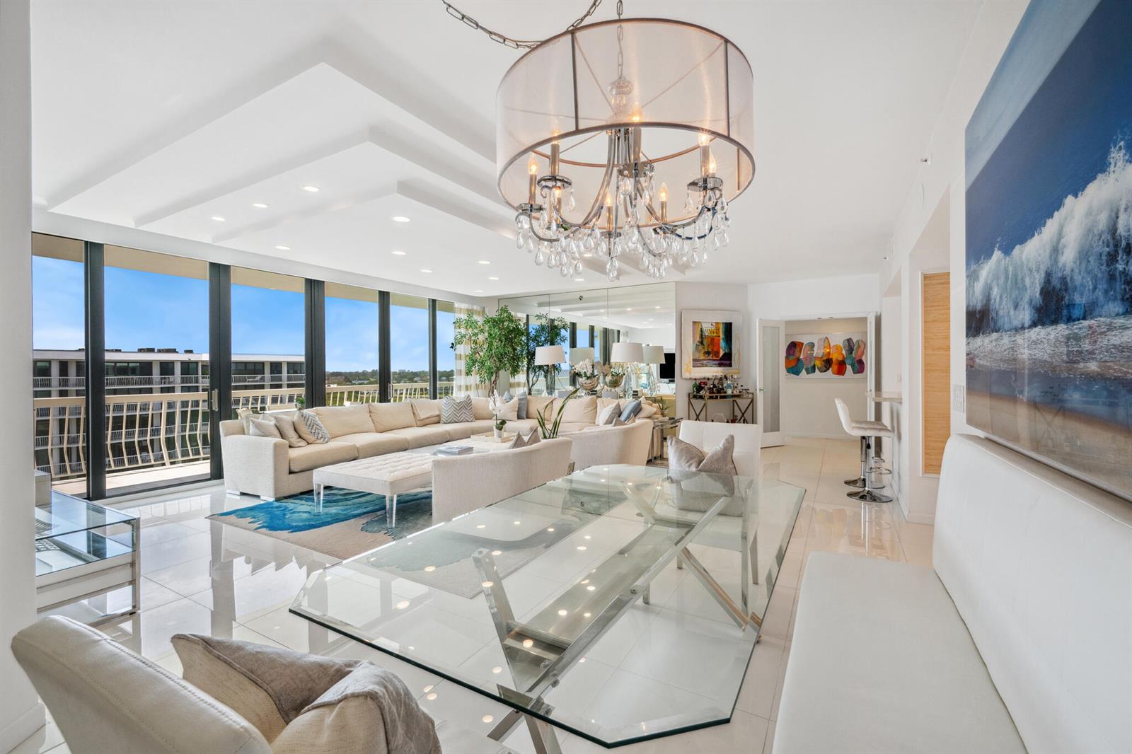A bright living and dining area features a glass table, large sectional, and floor-to-ceiling windows — 2100 S Ocean Boulevard # 607n, Palm Beach FL 33480, PALM BEACH, FL