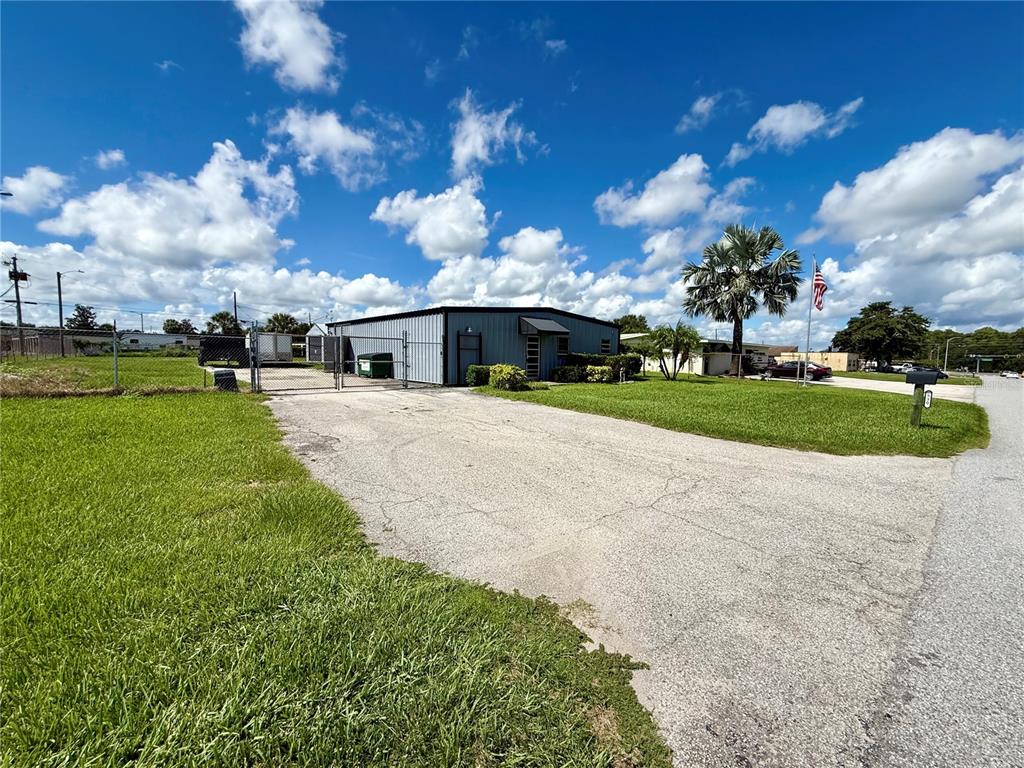 A single-story metal commercial building sits on a grassy lot with a paved driveway — 530 W BRANNEN ROAD, LAKELAND, FL