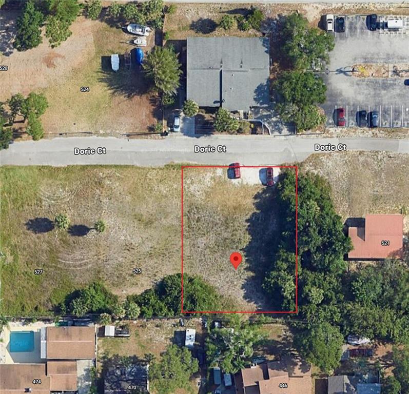 This aerial view shows a vacant rectangular lot outlined in red on a residential street — 523 DORIC COURT, TARPON SPRINGS, FL