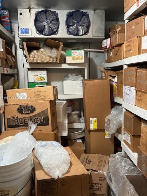 This walk-in freezer is filled with stacked cardboard boxes and plastic-wrapped food supplies — 163rd, North Miami Beach FL 33162, NORTH MIAMI BEACH, FL