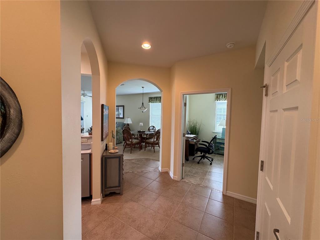 A tiled entryway leads to a dining area and a home office with glass doors — 20096 PEZZANA DRIVE, VENICE, FL