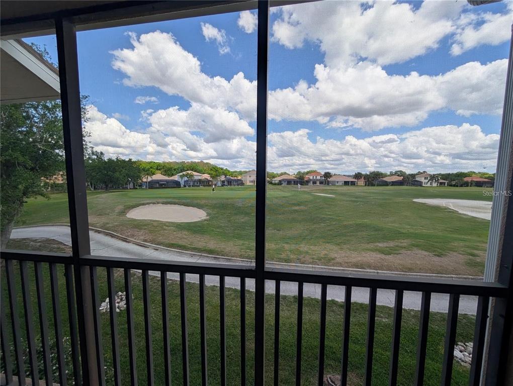 A view of a golf course from a screened-in porch — 803 FAIRWAYCOVE LANE UNIT 204, BRADENTON, FL