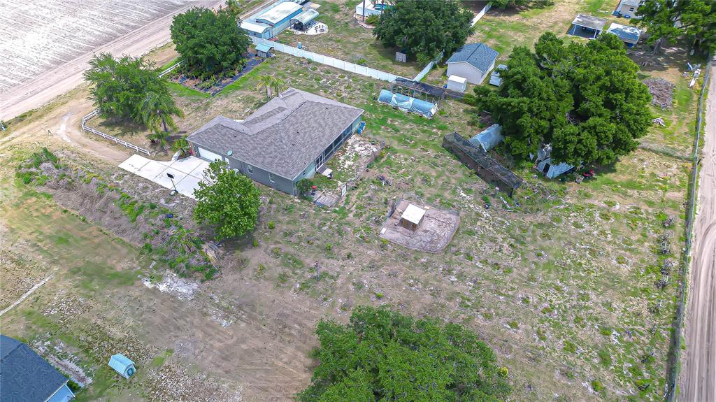 An aerial view shows a single-story house with a screened patio on a large lot — 4036 MOORES LAKE ROAD, DOVER, FL