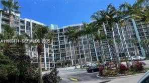 A multi-story residential apartment building with palm trees and a parking lot in front — 200 Leslie Dr # 303, Hallandale Beach FL 33009, HALLANDALE BEACH, FL