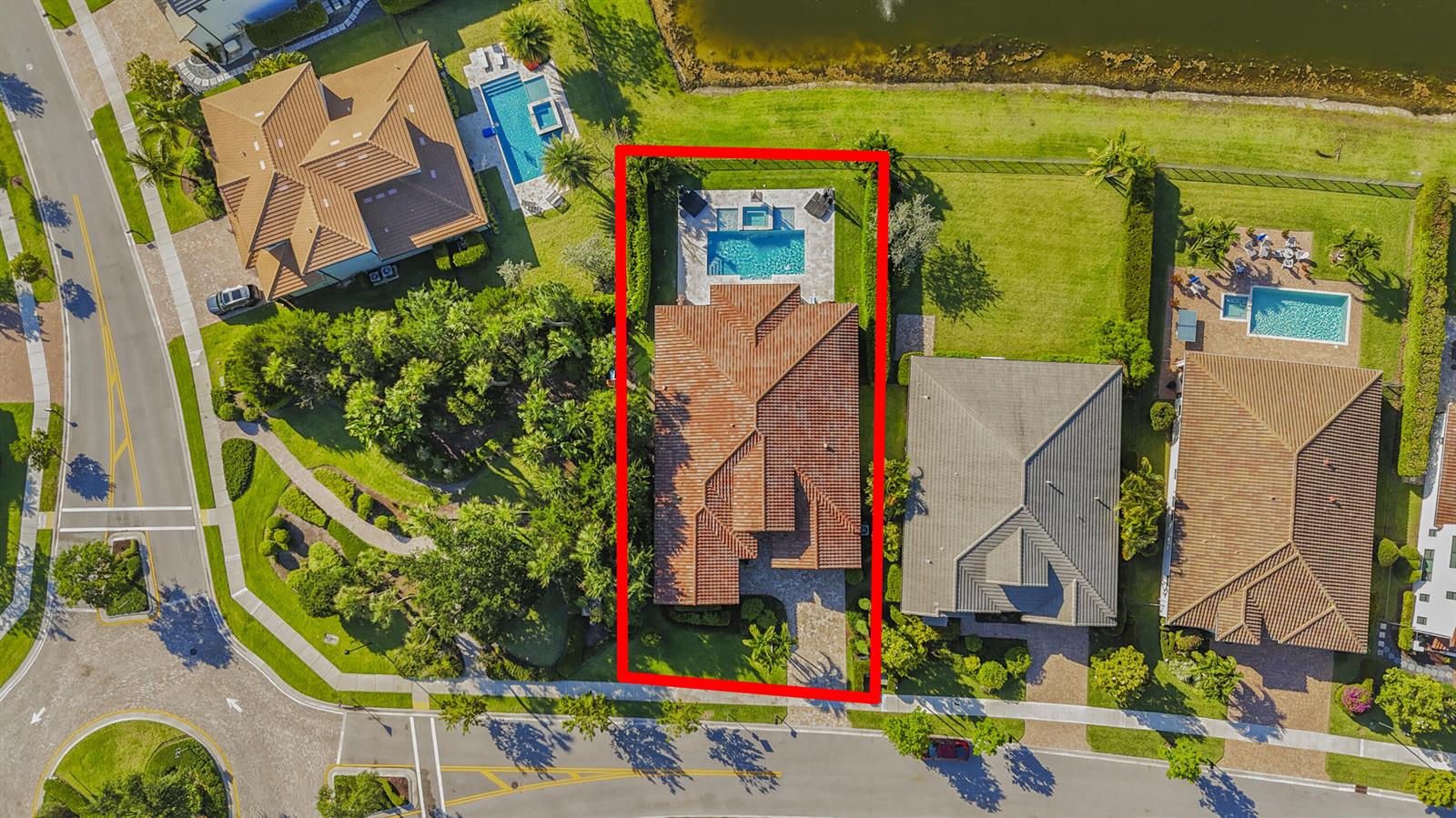 An aerial view shows a residential house with a tiled roof, pool, and backyard landscaping — 9387 Grand Prix Lane, Boynton Beach FL 33472, BOYNTON BEACH, FL