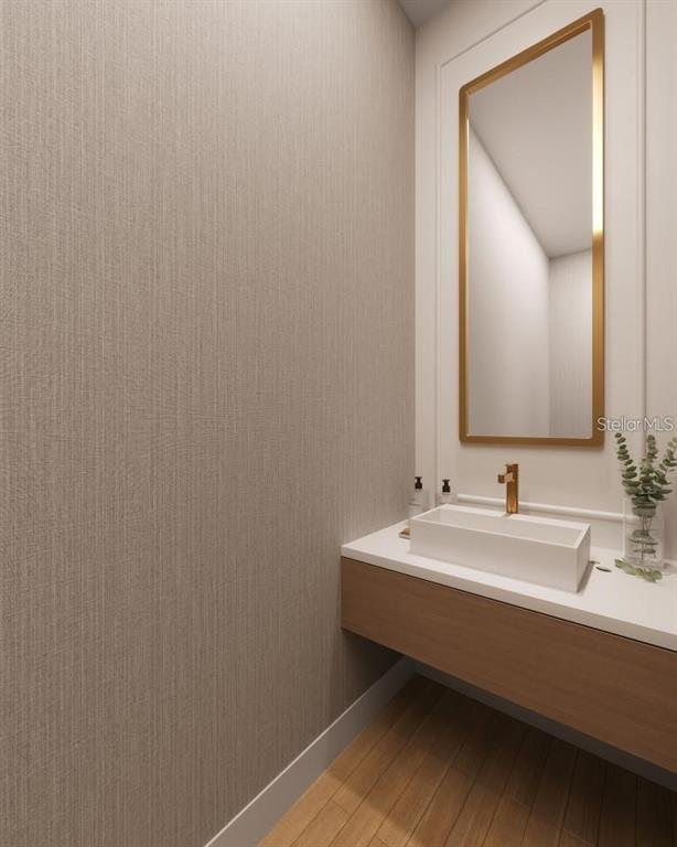 This is a rendering of a modern powder room with a floating vanity and gold mirror — 642 MEDORA WAY, WINTER GARDEN, FL