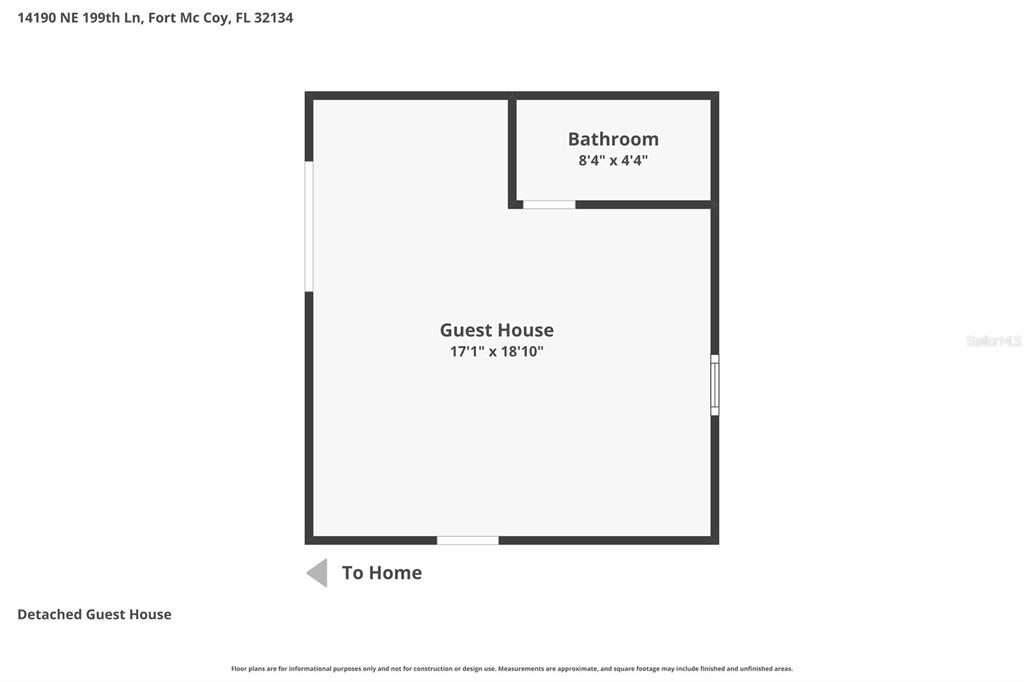 A two-story house with a large teal wooden deck and stairs sits on a grassy lot — 14190 NE 199TH LANE, FORT MC COY, FL