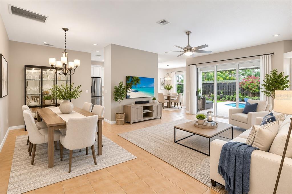 An open-concept living and dining area features tile floors, neutral walls, and a sliding glass door — 5425 MATTHEW COURT, SARASOTA, FL