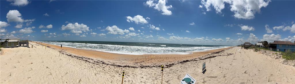 A panoramic view of a sandy beach with ocean waves and nearby coastal houses — 16 OCEANSIDE DRIVE, PALM COAST, FL