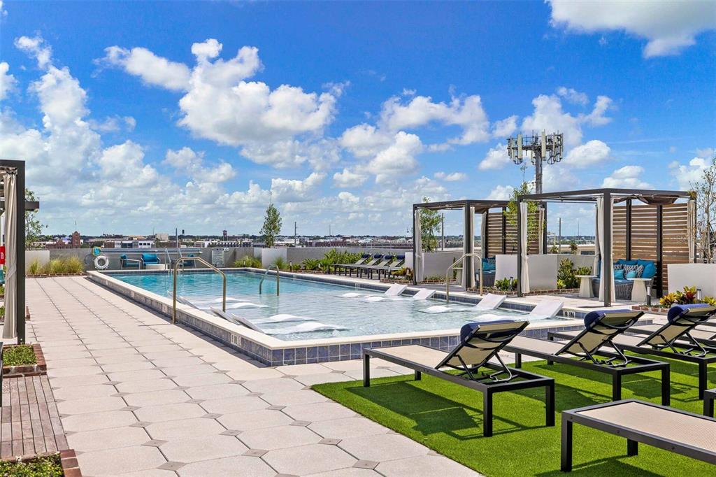 A rooftop swimming pool with lounge chairs and cabanas under a bright blue sky — 601 N 12TH STREET N UNIT A10, TAMPA, FL