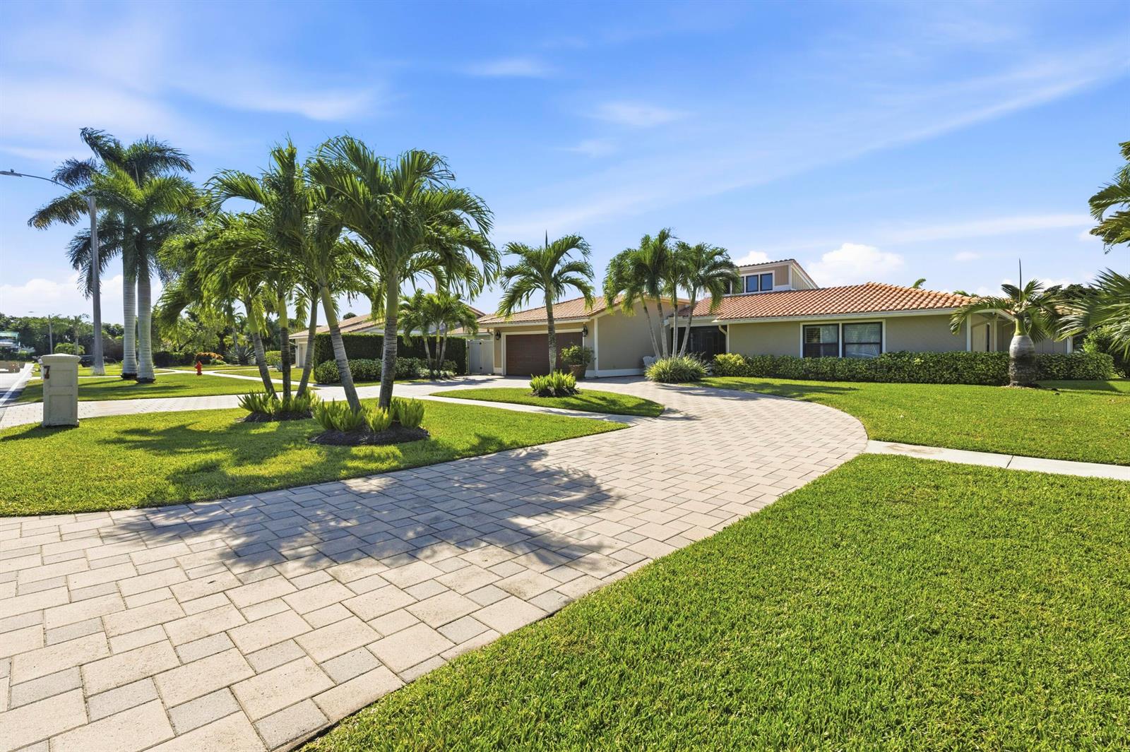 A single-story house with a tiled roof and a paved driveway surrounded by palm trees — 11327 Wingfoot Drive, Boynton Beach FL 33437, BOYNTON BEACH, FL