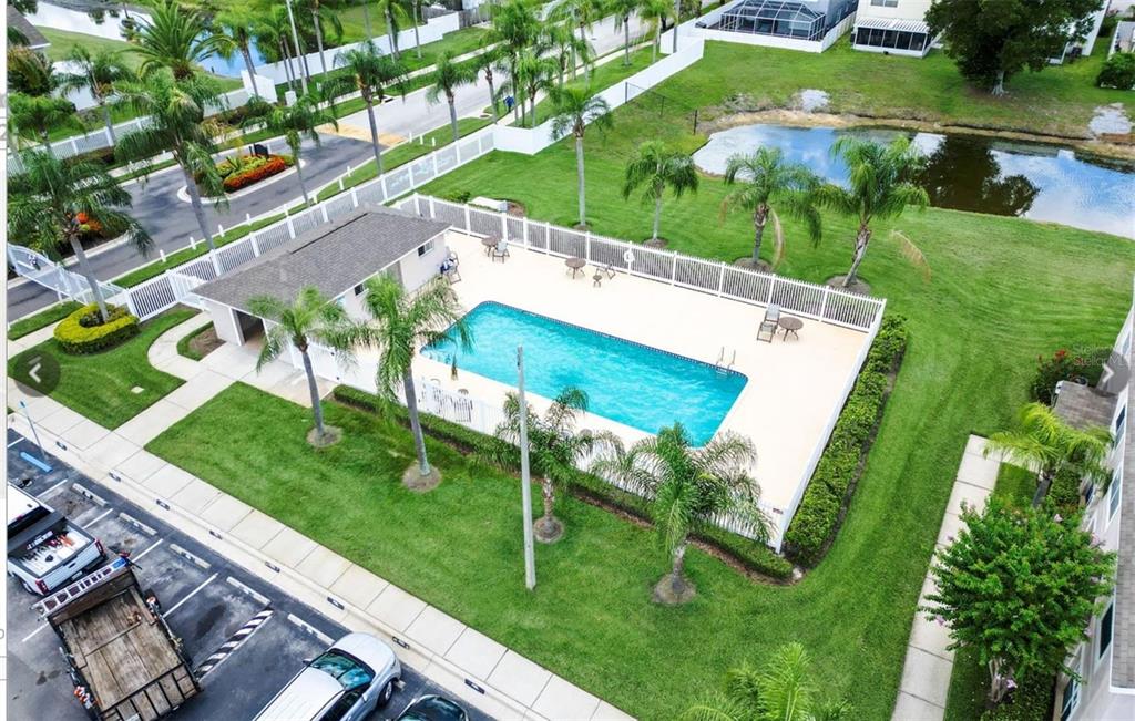 A two-story residential building features tan siding, multiple windows, and a palm tree out front — 734 KENSINGTON LAKE CIR UNIT BRANDON, BRANDON, FL