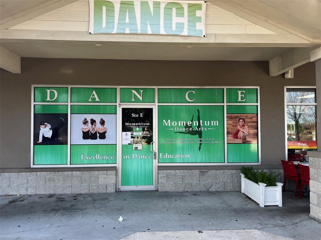 The exterior of a dance studio storefront features green signage and large window decals — 15634 NW US HIGHWAY 441 UNIT E, ALACHUA, FL