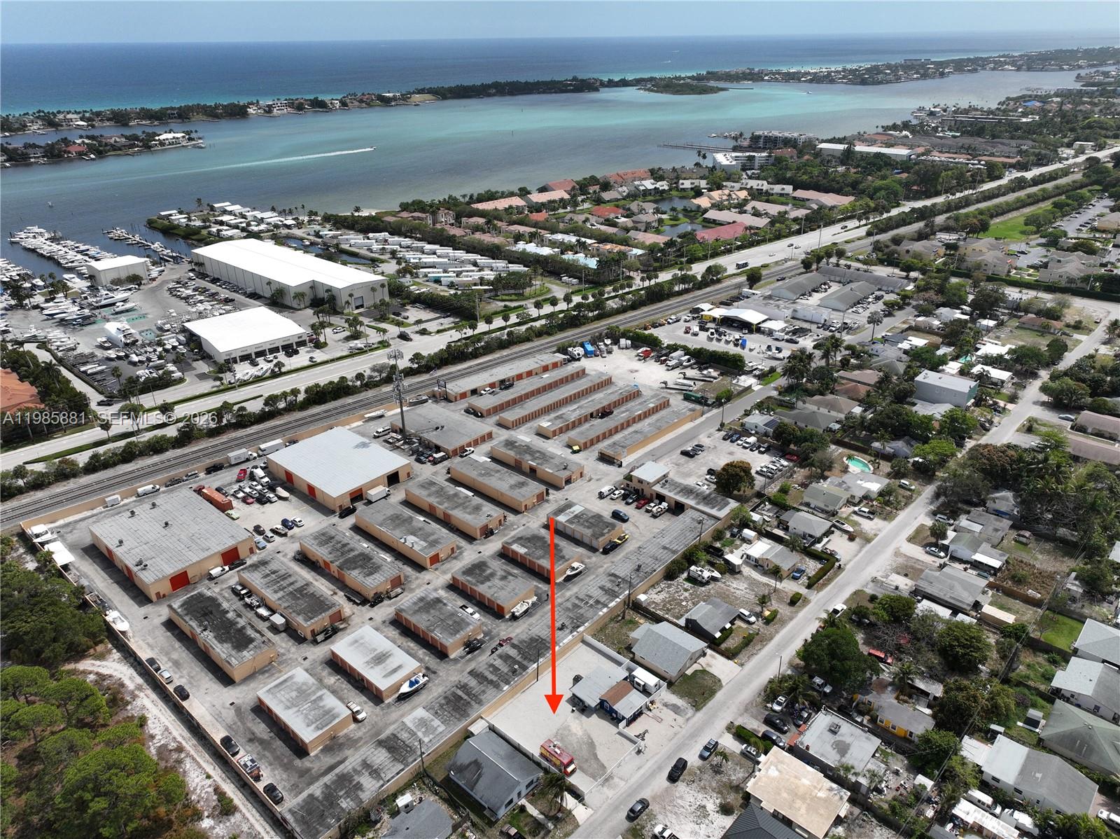 An aerial view shows a commercial storage facility with multiple buildings and a red vehicle — 7772 Loomis St, Hypoluxo FL 33462, HYPOLUXO, FL