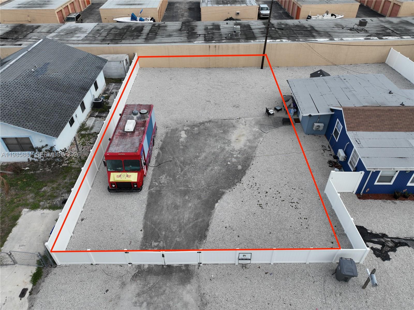 An aerial view shows a fenced, gravel-covered lot containing a food truck — 7772 Loomis St, Hypoluxo FL 33462, HYPOLUXO, FL