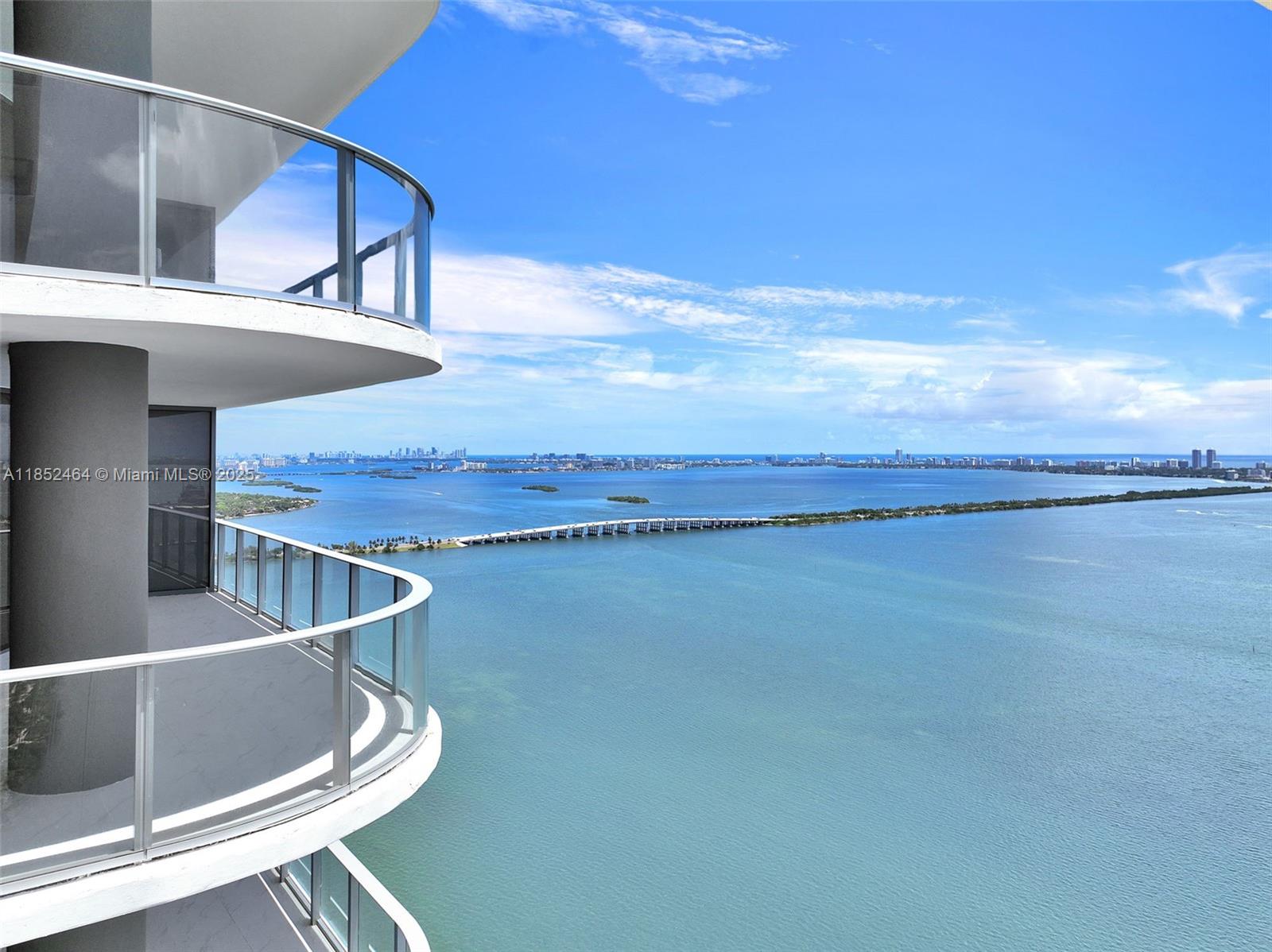 A high-rise balcony overlooks a large body of water and a long bridge — 700 Ne 24th St # 4507, Miami FL 33137, MIAMI, FL