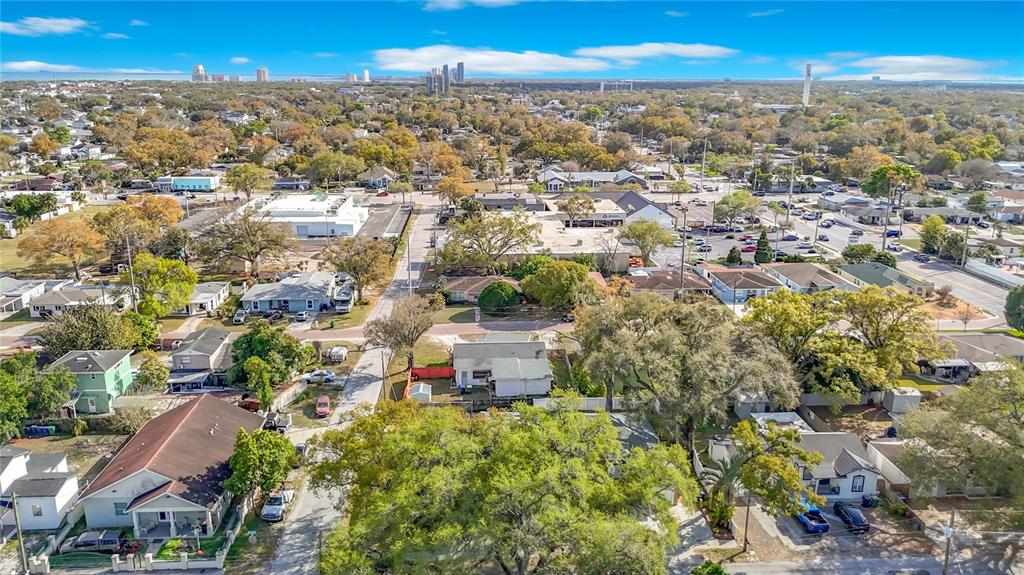An aerial view of a residential neighborhood with houses, trees, and a commercial shopping center — 3002 W ARCH STREET, TAMPA, FL
