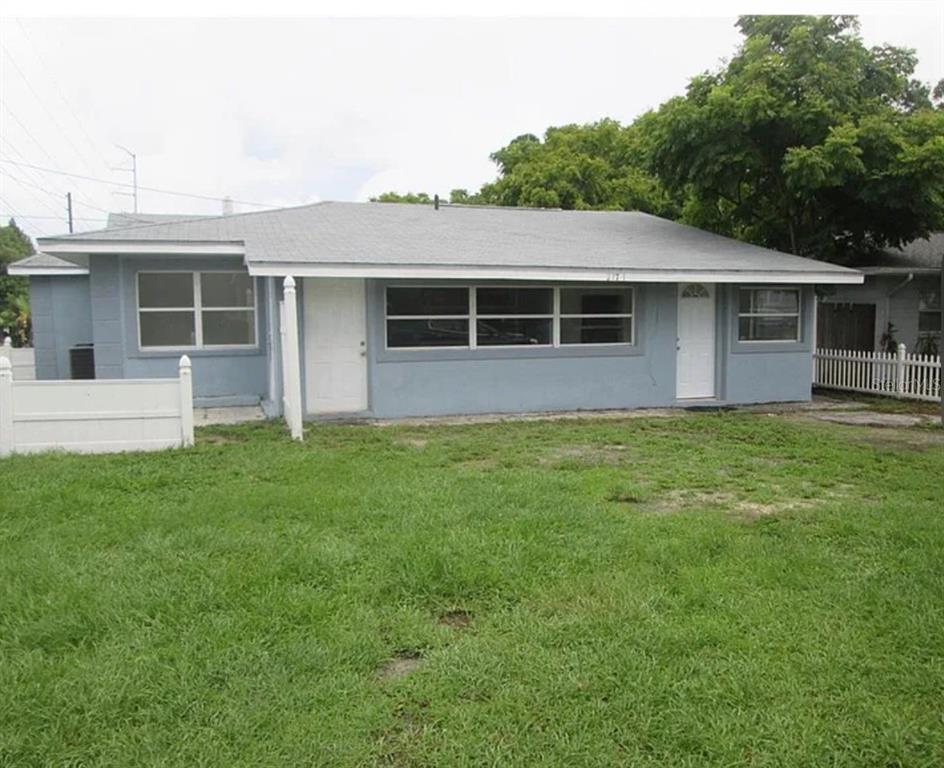 A single-story gray house with a white door and a large front yard — 5901 28TH STREET N, ST PETERSBURG, FL