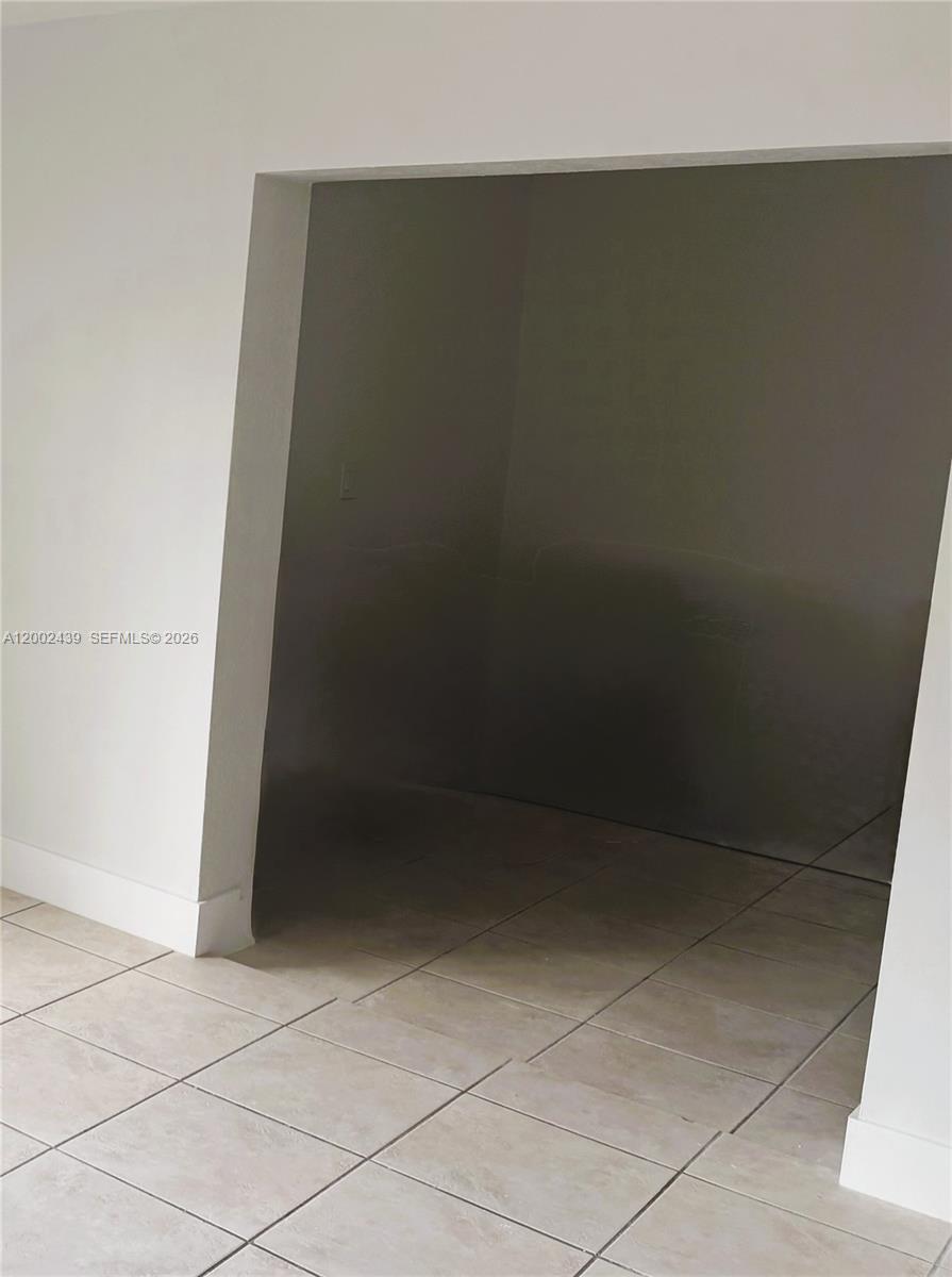 A room with light-colored tile flooring features a large, dark, recessed alcove area — 3743 NW 122nd Ter, Sunrise FL 33323, SUNRISE, FL