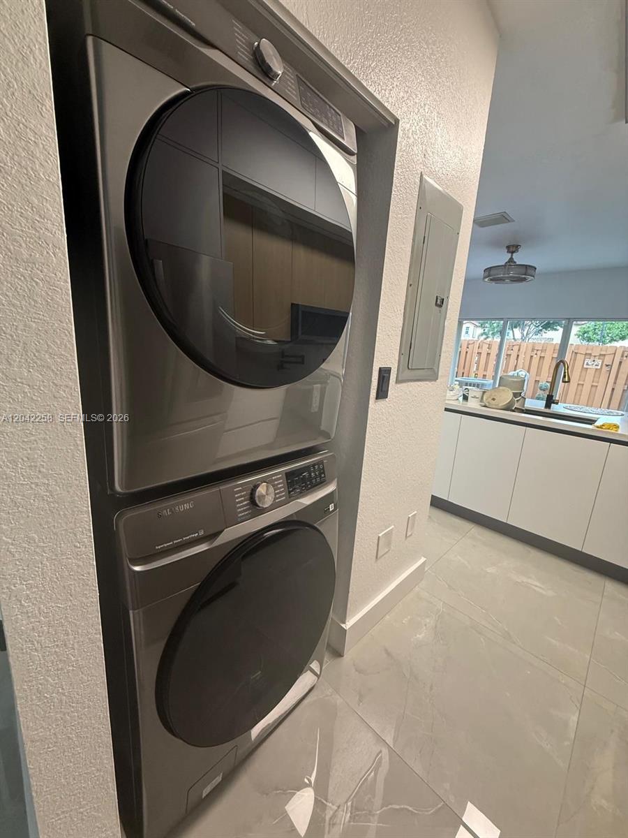 A stacked Samsung washer and dryer unit is installed in a tiled laundry area — 3370 NE 14th Dr # 29, Homestead FL 33033, HOMESTEAD, FL