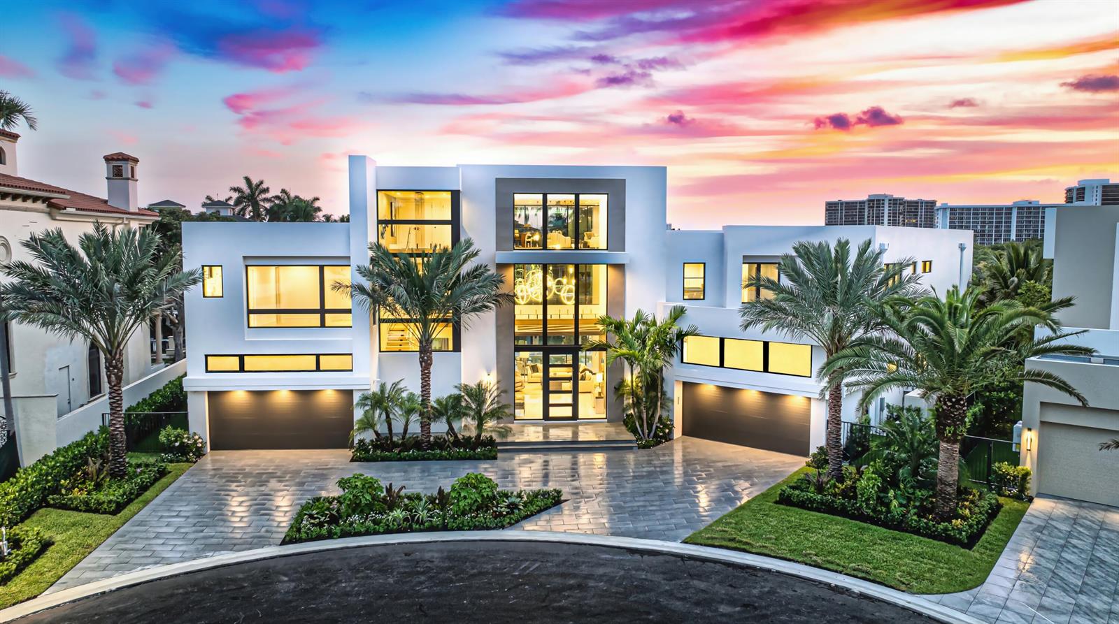 A modern two-story house with a paved driveway, palm trees, and a sunset sky background — 4111 Ibis Point Circle, Boca Raton FL 33431, BOCA RATON, FL