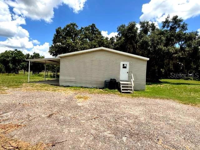 A bathroom features a toilet, a bathtub, and unfinished wall surfaces with exposed plumbing — 5411 PLESS ROAD, PLANT CITY, FL