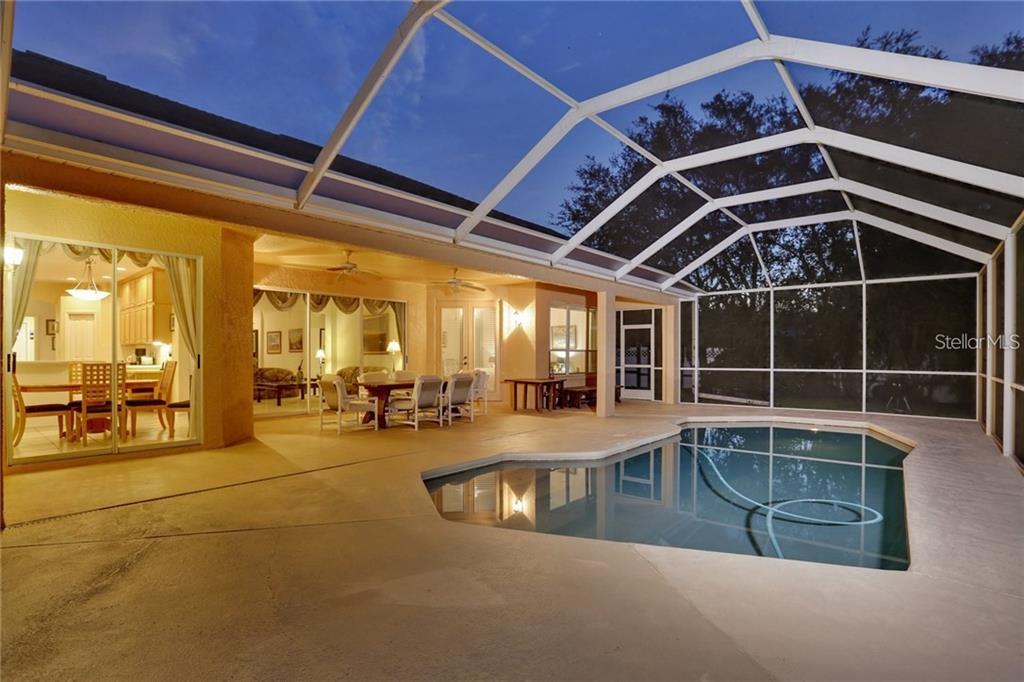 A screened-in patio features a swimming pool, outdoor dining area, and sliding glass door access — 6020 CATLIN DRIVE, TAMPA, FL