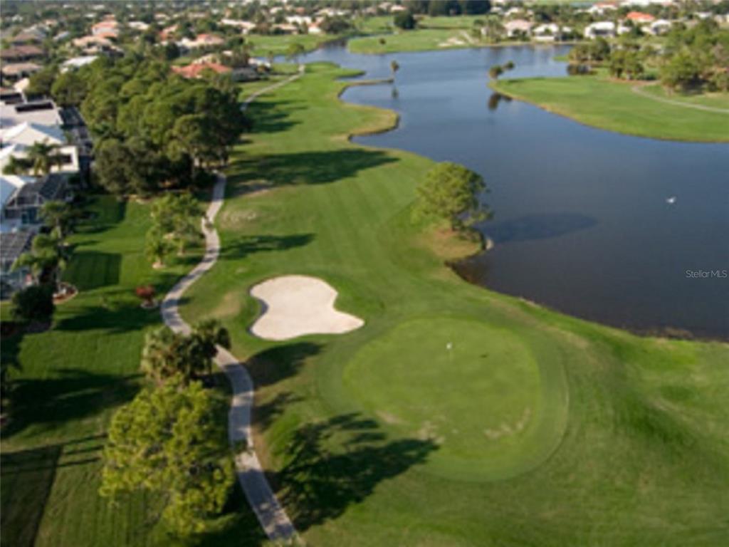 An aerial view of a golf course green, sand trap, and adjacent pond — 1155 BOUNDARY BOULEVARD, ROTONDA WEST, FL