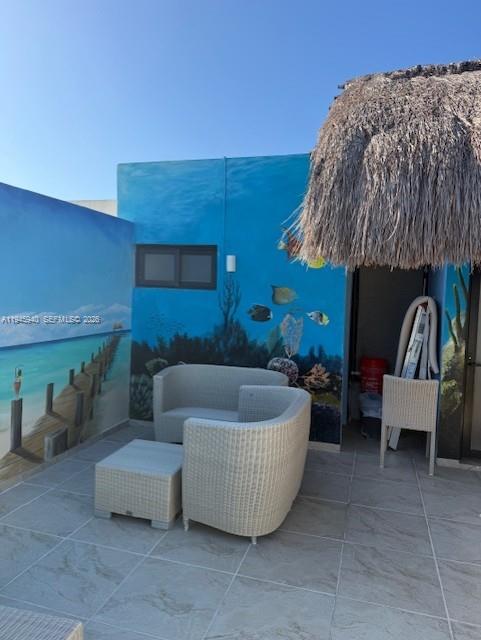 An outdoor patio features wicker furniture, tiled flooring, and walls painted with underwater murals — 1405 25 th street # 1405, MX, MX