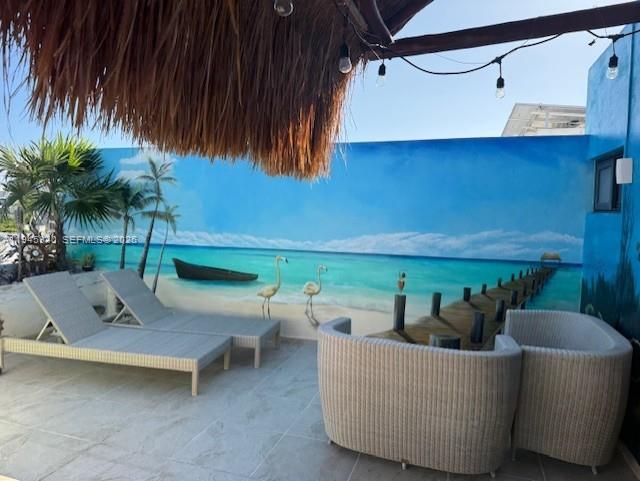 A patio features lounge chairs, curved wicker seating, and a mural of a tropical beach — 1405 25 th street # 1405, MX, MX