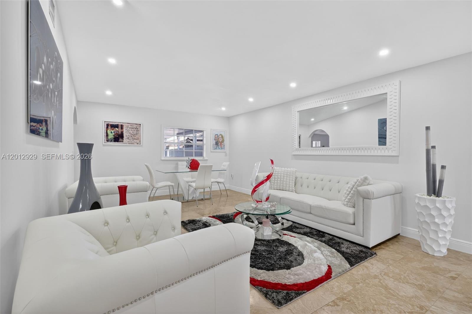 A living and dining room features white tufted furniture, a glass table, and a patterned rug — 14661 SW 168th Ter, Miami FL 33177, MIAMI, FL