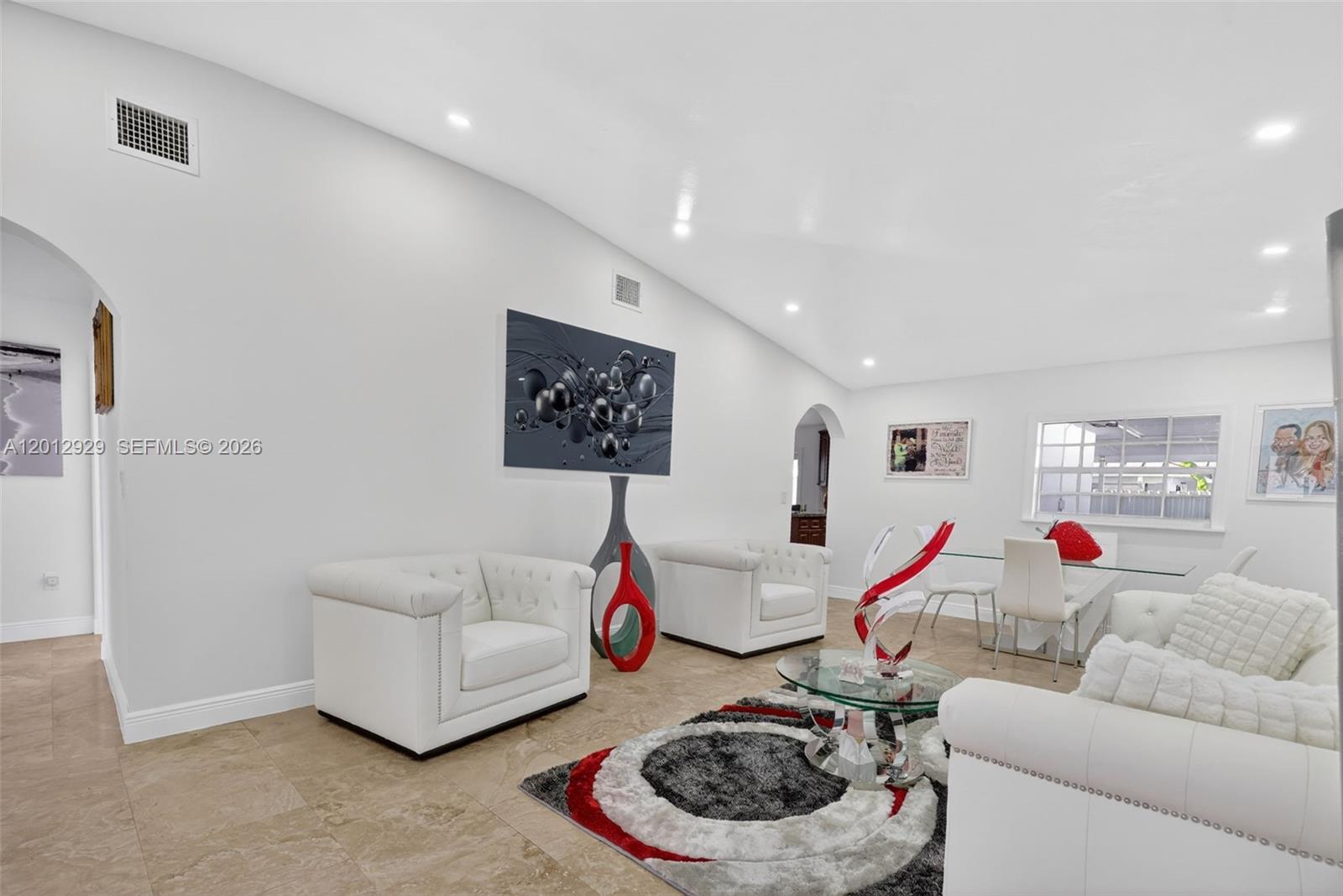 A living and dining area features white tufted furniture, tile flooring, and a patterned rug — 14661 SW 168th Ter, Miami FL 33177, MIAMI, FL