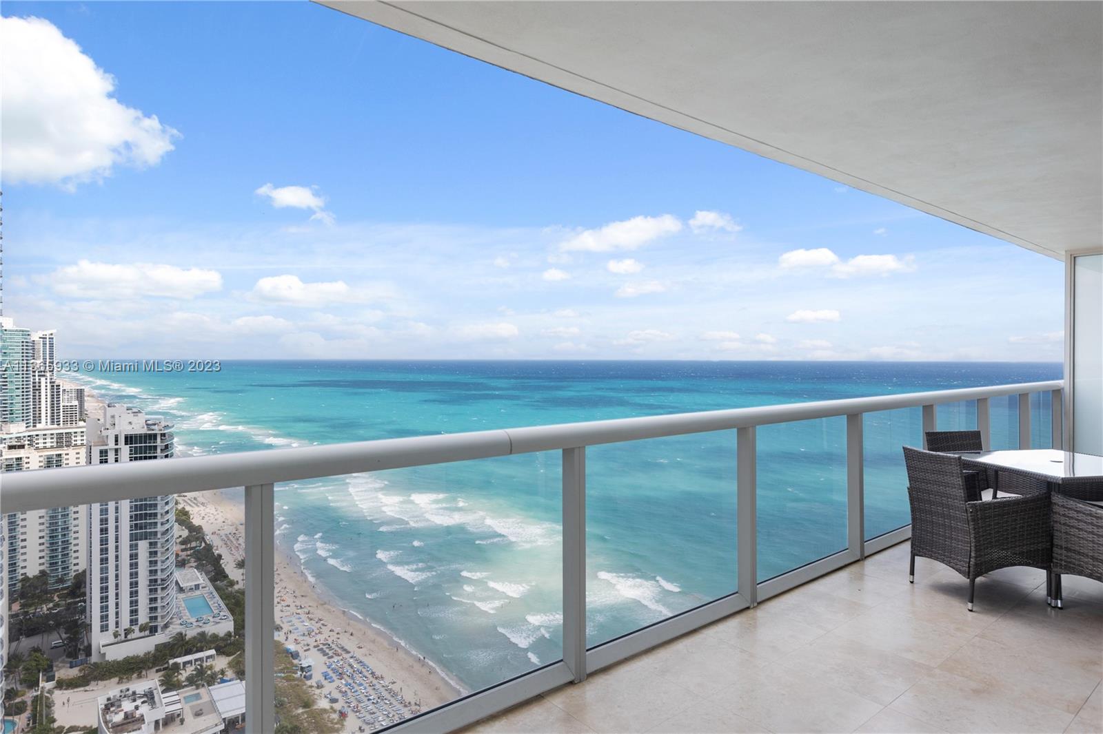 A high-rise balcony overlooks the ocean and beach with a small outdoor dining set — 1830 S Ocean Dr Available # 3511, Hallandale Beach FL 33009, HALLANDALE BEACH, FL