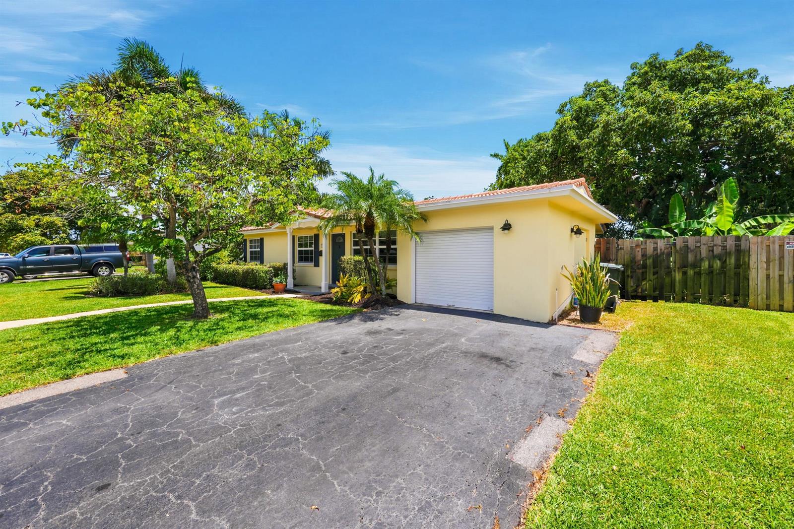 A yellow single-story house with a white garage door and a paved driveway — 1222 SW 5th Street, Boca Raton FL 33486, BOCA RATON, FL