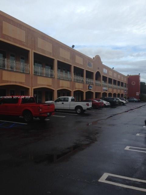 A multi-story commercial building with a parking lot in the foreground — 5911 NW 173rd Dr, Hialeah FL 33015, HIALEAH, FL